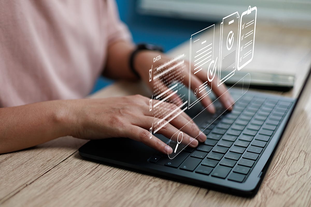 Hands typing on laptop with hologram digital search data interface, representing online document management, data processing, workflow automation, and modern technology digital business